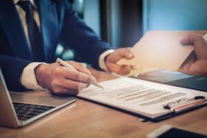 The personal injury attorney receiving fees in a envelop from the client