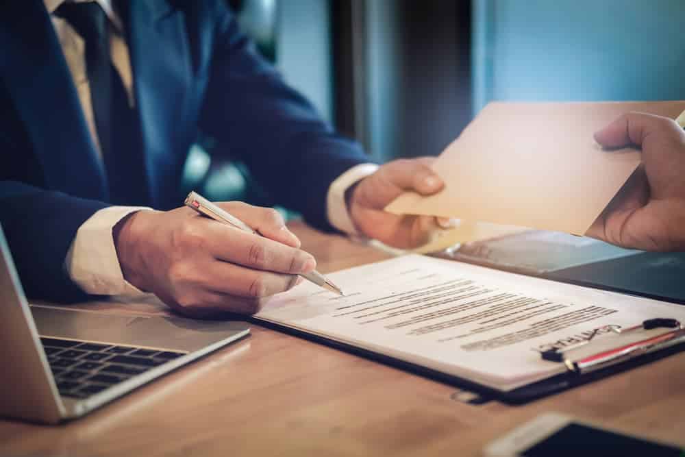 The personal injury attorney receiving fees in a envelop from the client