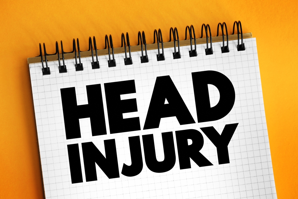 Notebook with the words Head Injury written on the cover, symbolizing medical and legal claims after a brain injury