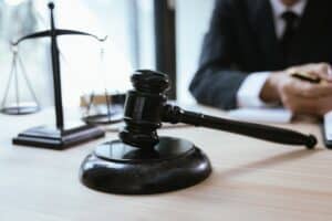 Judge’s gavel and scales of justice on a lawyer’s desk representing a personal injury lawsuit.