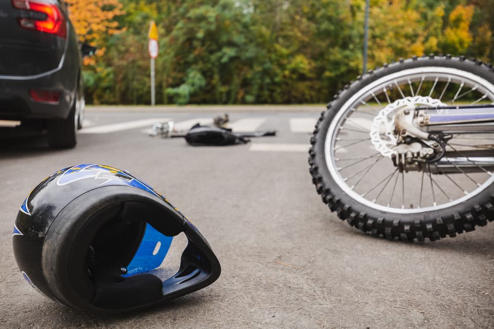 Motorcycle and the car after the collision on the road
